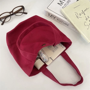 Detail view of burgundy canvas tote bag interior showing spacious storage for essentials