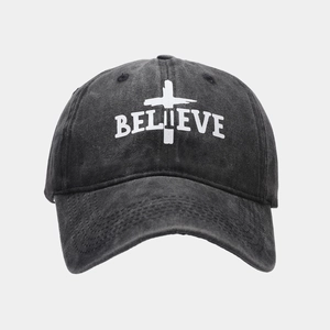 Detail of the BELIEVE letter print and cross graphic on a vintage grey baseball cap