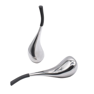 Detailed macro view of dual stainless steel facial cooling globes with black handles
