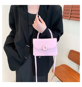 Chic pink PU leather square handbag with golden hardware shown with black stylish outfit