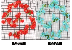 Detalle de enredaderas de flores artificiales rojas y azules para decorar tuberías