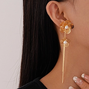 Elegant gold hollow flower tassel earrings with sparkling zircon for a stylish look