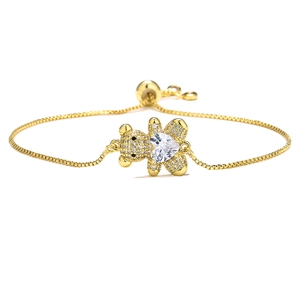 Detail view of adjustable gold bear bracelet with heart-shaped stone and zircon pavé