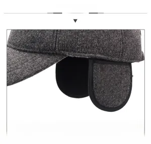 Detail of warm winter baseball cap with ear flaps in dark grey tweed fabric