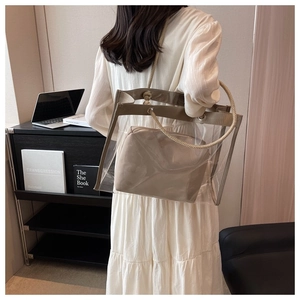 Detail of transparent PVC tote bag with leather trim and thick rope knot handle straps