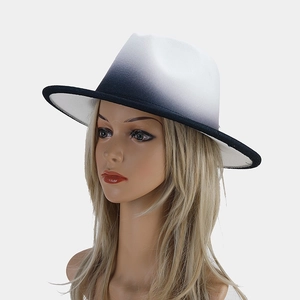 Detail of gradient felt fedora hat showing smooth black and white ombre transition effect