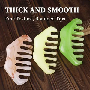 Ergonomic wide tooth meridian scalp massage comb available in amber and jade colors