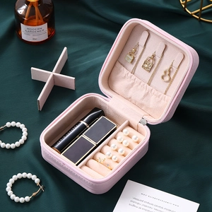 Pink faux leather travel jewelry box with zipper and multi-compartment interior storage