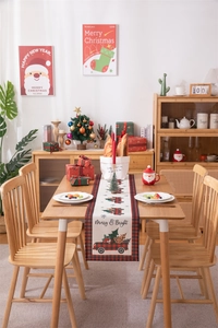 Detail view of Merry & Bright Christmas table runner with red truck on wood table