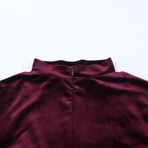 Detail of burgundy velvet collar with high-quality invisible zipper on a slim jumpsuit