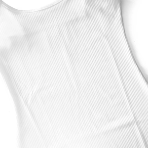 Detailed macro view showing the texture of premium white ribbed knit fabric on a dress