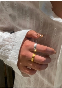 Close-up of stacked 18k gold plated hammered texture ring and silver micro-pave band