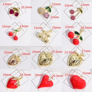 Golden fruit charms with red enamel strawberry and cherry patterns in various sizes