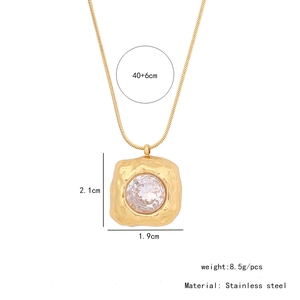 Detail of stainless steel necklace with irregular pendant and embedded white crystal