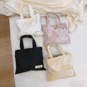 Mini jacquard canvas handbags with bow embroidery in white, pink, black, and beige