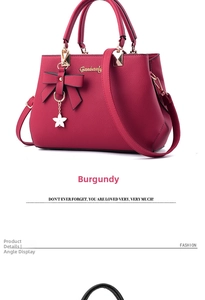 Detail of wine red handbag featuring a bow ornament and adjustable long shoulder strap