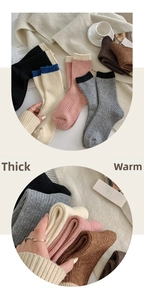 Close-up of color-block ribbed wool socks showing thick knit texture and soft fabric