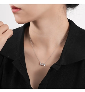 Close-up of minimalist sterling silver necklace with three geometric cubic zirconia stones