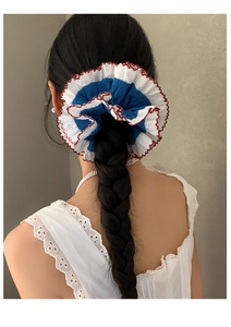 Detailed view of a tricolor lace scrunchie worn on a high ponytail with elegant red piping