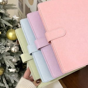 Macro shot of glitter PU leather binders in four macaron colors with snap buttons