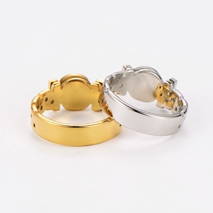 Detail of stacked gold and silver stainless steel rings with Roman numerals side view