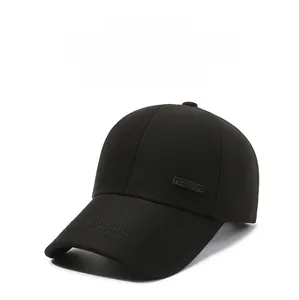 Detail of black twill baseball cap with three-stitch brim and side metal logo accent
