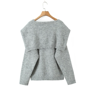 Detail of grey knit sweater showing thick shawl collar and fine ribbed texture edges
