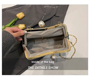 Detail view of pearl clasp, gold metal frame and interior zipper pocket of the shell bag