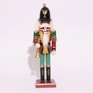 Detail of wooden nutcracker soldier holding golden trumpet for Christmas decor