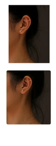 Detailed view of sterling silver geometric ear studs with clear zircons on model ear