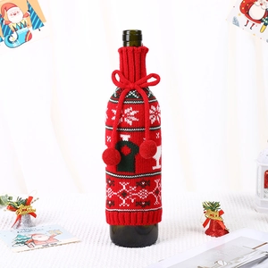 Christmas knit wine bottle cover with red snowflake pattern and pompom drawstring