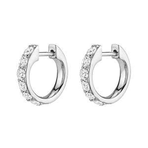 Macro detail of silver huggie earrings featuring sparkling pave-set cubic zirconia stones