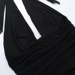 Close-up of black halter neckline with mesh patchwork and pleated fabric texture