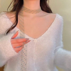 Detailed view of a gold mesh choker necklace with light blue round crystal beads