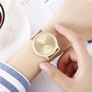Minimalist gold quartz watch featuring a sunburst dial and metal mesh strap for women
