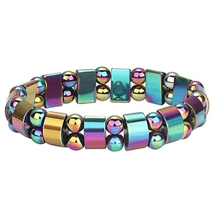 Macro shot of elastic bracelet featuring iridescent magnetic hematite beads on white base