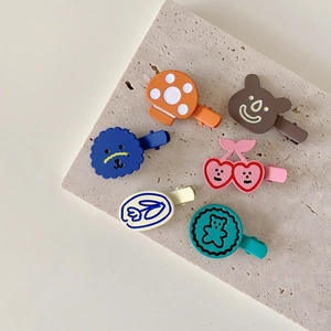 Set of 6 colorful cartoon hair clips featuring mushroom and cherry designs on stone