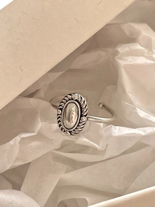 Macro detail of a vintage oval silver ring presented in an elegant gift box set