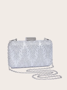 Close-up of sparkling silver rhinestones and detachable metal chain on evening bag