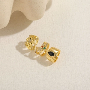 Detailed view of three 14K gold plated rings with zircon and vintage carvings