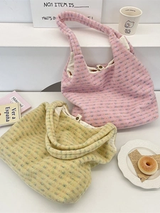 Plush tote bags in pink and yellow with soft ribbed texture and magnetic metal closure