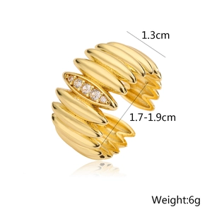 Detail view of 18K gold plated ring with five zircon stones and wide wavy texture