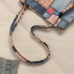 Blue denim patchwork tote bag with pink pattern accents and dual slim shoulder straps