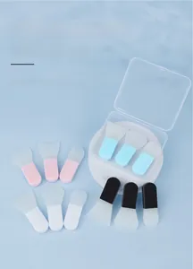Mini silicone facial mask brushes in pink and blue with a portable clear storage case