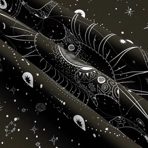 Close-up detail of celestial sun and moon print on high-quality black textile fabric