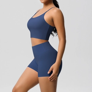 Close-up of seamless dark blue yoga set with high waist shorts and thin strap sports bra