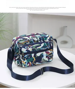 Detail of multi-layer storage and colorful camo pattern on nylon crossbody sport bag