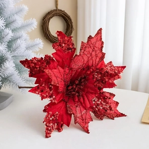 Close-up of a 20cm red poinsettia Christmas flower with glitter sequins and velvet texture