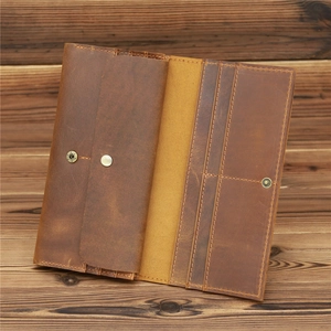 Detail view of vintage crazy horse leather long wallet with card slots and snap button