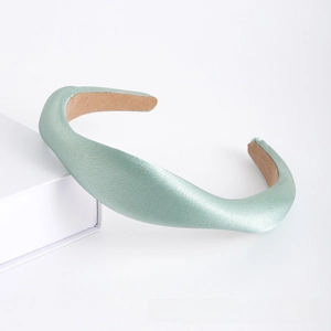Detail of mint green satin headband with thick padded design and non-slip lining